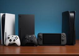 Top gaming consoles with controllers and game cases arranged on a modern entertainment center